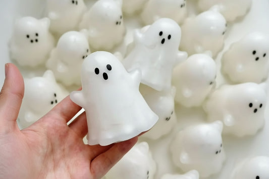 hand holding a white halloween  ghost crunchy squishy 